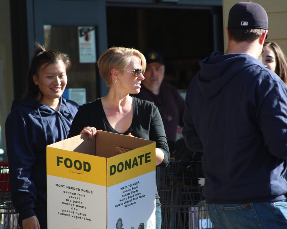 Volunteer with food donation box