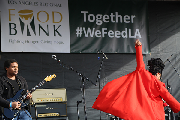 Band on stage under Food Bank banner