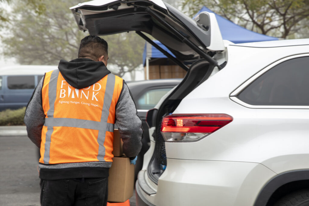 A volunteer at the Magic Johnson drive-through distribution