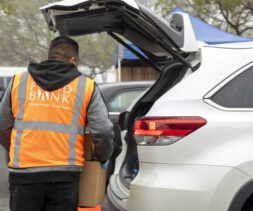 A volunteer at the Magic Johnson drive-through distribution