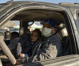 Julio with his young son at a food distribution at Sowing Seeds for Life in Pomona, California.